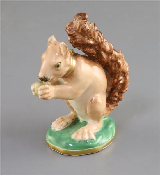 A Rockingham porcelain figure of a seated squirrel, c.1830, H. 7.8cm, splinter chip to one ear